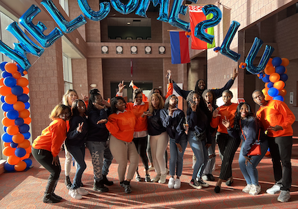 students standing under a Welcome 2 LU balloon arch